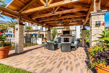 Outdoor kitchen with grills and pizza oven